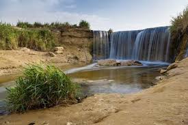 Wadi El Rayan waterfalls surrounded by desert cliffs in Fayoum Egypt